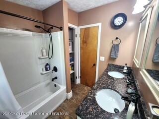 1048 Chris J Dr, Lansing, MI 48917 - full bath featuring shower / bathtub combination, double vanity, a textured ceiling, and tile patterned floors