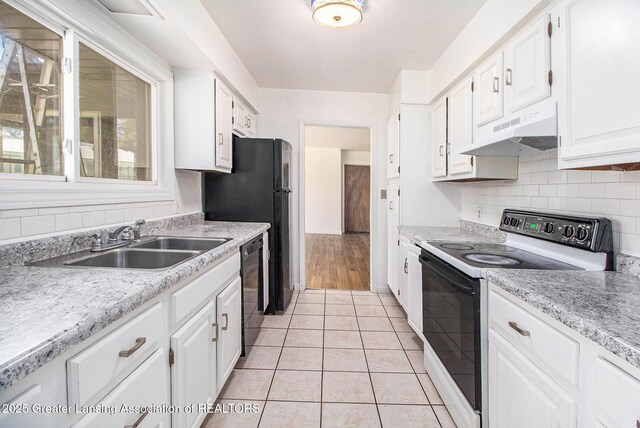 160 Lincoln Hill Dr, Battle Creek, MI 49015 - kitchen featuring electric range oven, under cabinet range hood, a sink, and white cabinetry