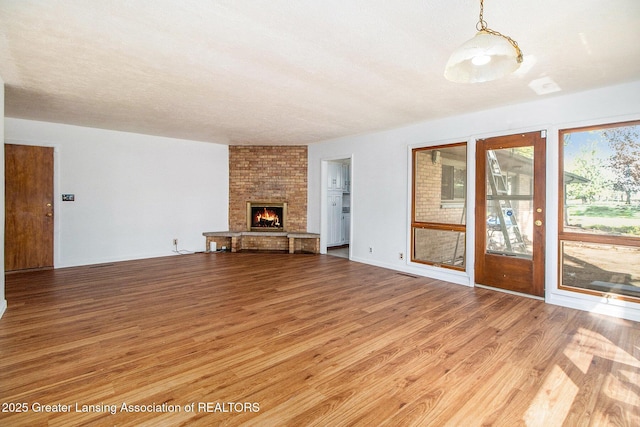 160 Lincoln Hill Dr, Battle Creek, MI 49015 - unfurnished living room featuring wood finished floors and a fireplace