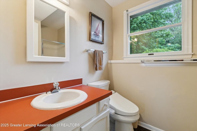 5080 Cornell Rd, Okemos, MI 48864 - bathroom featuring toilet, vanity, and a shower