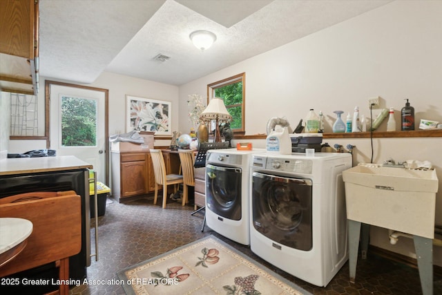 5080 Cornell Rd, Okemos, MI 48864 - washroom featuring washer and dryer, a textured ceiling, and a sink