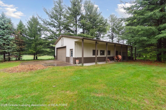 5080 Cornell Rd, Okemos, MI 48864 - back of house featuring a yard, a detached garage, concrete driveway, and an outdoor structure