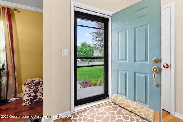 13503 Cottonwood Ct, Dewitt, MI 48820 - entryway featuring wood finished floors, baseboards, and crown molding