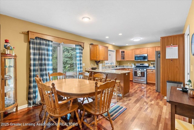 13503 Cottonwood Ct, Dewitt, MI 48820 - dining area with light wood-type flooring, baseboards, and recessed lighting