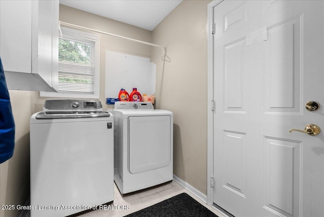 13503 Cottonwood Ct, Dewitt, MI 48820 - laundry area with independent washer and dryer, light tile patterned flooring, baseboards, and cabinet space