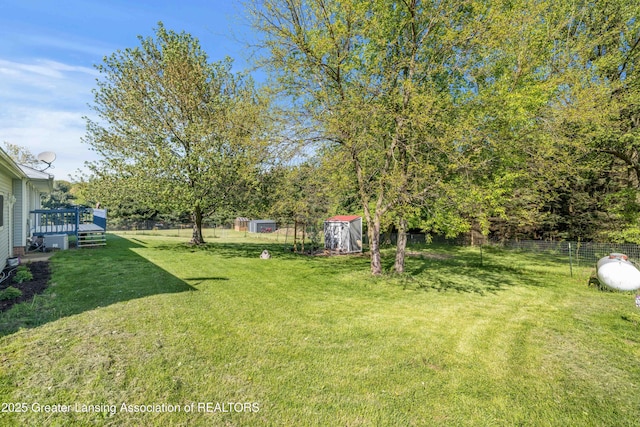 2335 N Concord Rd, Albion, MI 49224 - view of yard featuring a wooden deck, a storage unit, and an outbuilding