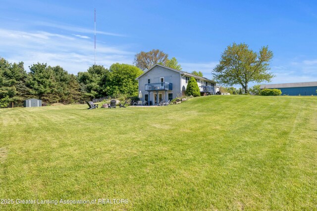 2335 N Concord Rd, Albion, MI 49224 - view of green lawn featuring a shed and an outbuilding