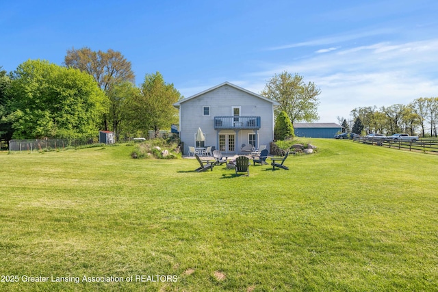 2335 N Concord Rd, Albion, MI 49224 - back of property featuring french doors and a fire pit