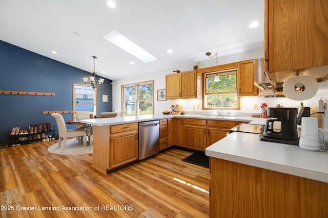 2335 N Concord Rd, Albion, MI 49224 - kitchen featuring stainless steel dishwasher, a skylight, a sink, a peninsula, and vaulted ceiling