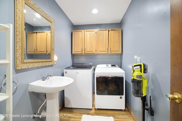 2335 N Concord Rd, Albion, MI 49224 - laundry room with washing machine and dryer, cabinet space, light wood-type flooring, and recessed lighting