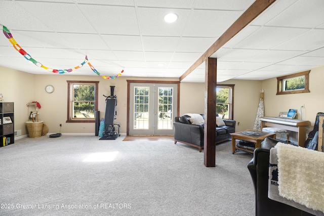 2335 N Concord Rd, Albion, MI 49224 - carpeted living room with a paneled ceiling, french doors, and baseboards