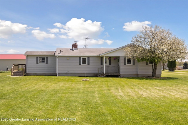 13321 Russell Rd, Lake Odessa, MI 48849 - rear view of house featuring a yard and a chimney