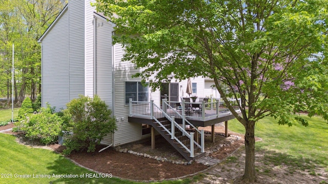 rear view of property with a wooden deck, stairs, a yard, and a chimney
