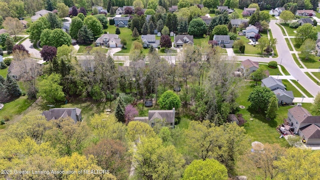 aerial view of property and surrounding area with nearby suburban area