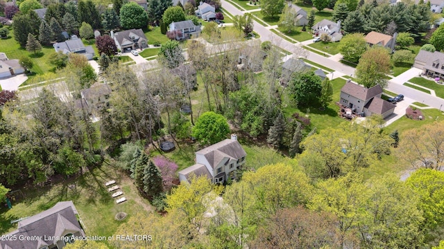 aerial view of property and surrounding area featuring nearby suburban area