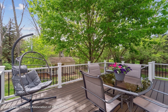wooden terrace with outdoor dining space
