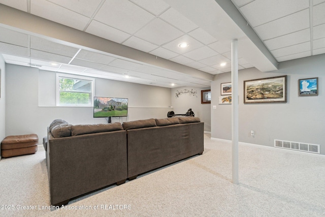 carpeted living area featuring a drop ceiling, baseboards, and recessed lighting