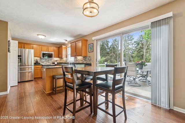 dining room featuring hardwood / wood-style floors and baseboards
