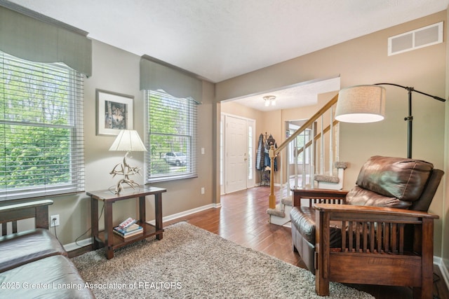 entrance foyer with wood finished floors, baseboards, and stairs