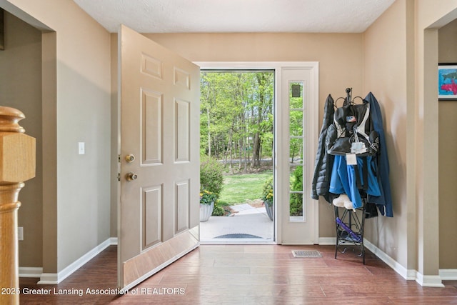 entrance foyer with wood finished floors and baseboards