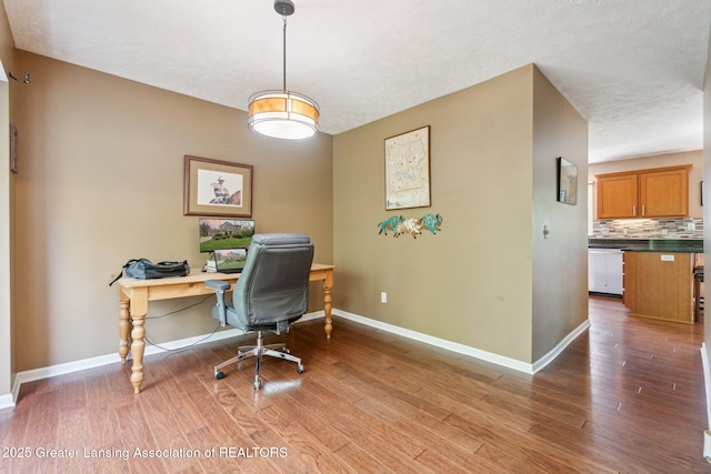 office area with wood finished floors and baseboards