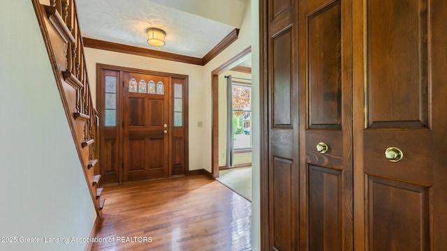 4245 Sandridge Dr, Okemos, MI 48864 - foyer with crown molding, light wood-style floors, baseboards, and stairs