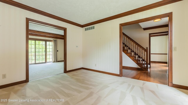 4245 Sandridge Dr, Okemos, MI 48864 - spare room with carpet floors, crown molding, stairs, and baseboards