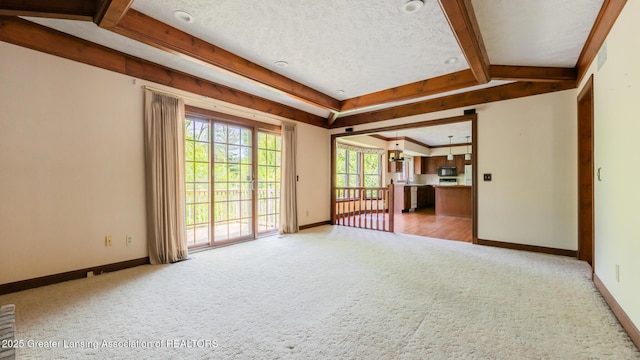 4245 Sandridge Dr, Okemos, MI 48864 - unfurnished living room with carpet, baseboards, and beam ceiling