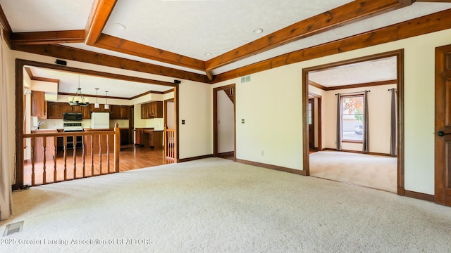4245 Sandridge Dr, Okemos, MI 48864 - unfurnished living room with carpet, baseboards, and beamed ceiling