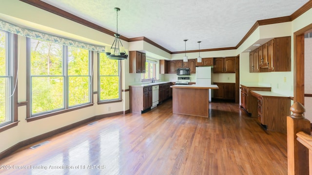 4245 Sandridge Dr, Okemos, MI 48864 - kitchen featuring white appliances, a kitchen island, dark wood-style floors, a textured ceiling, and light countertops