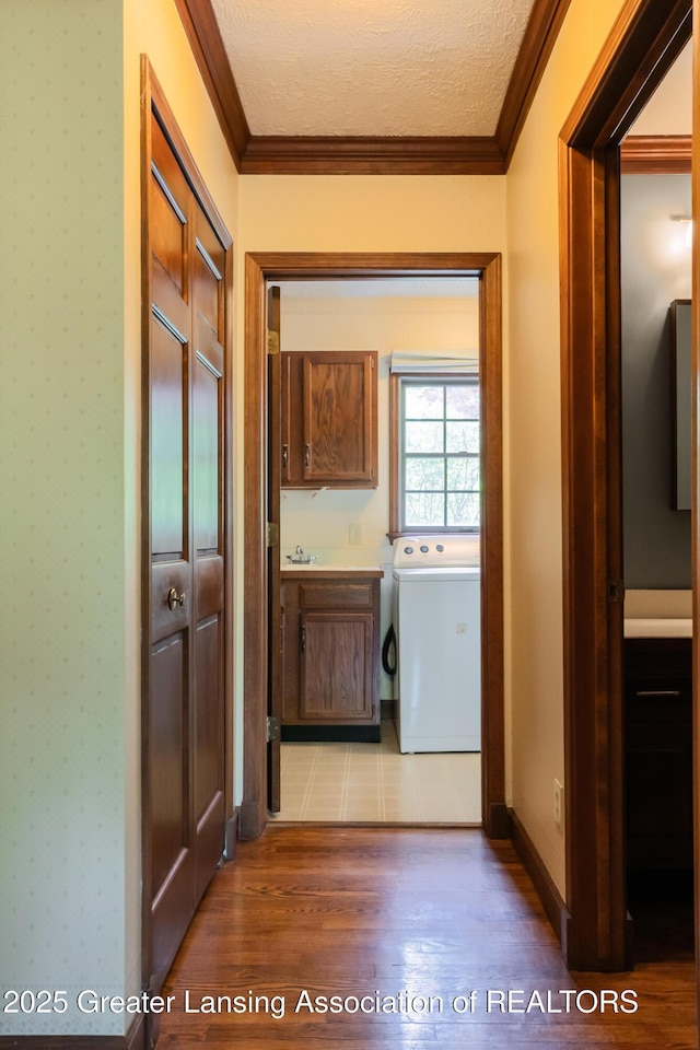 4245 Sandridge Dr, Okemos, MI 48864 - laundry area with washer / dryer, cabinet space, crown molding, wood finished floors, and a textured ceiling