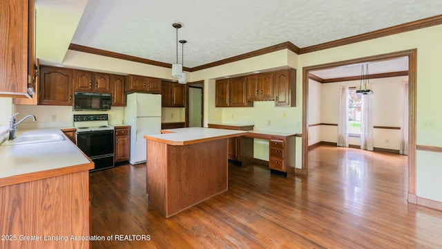 4245 Sandridge Dr, Okemos, MI 48864 - kitchen with electric stove, freestanding refrigerator, black microwave, a sink, and light countertops