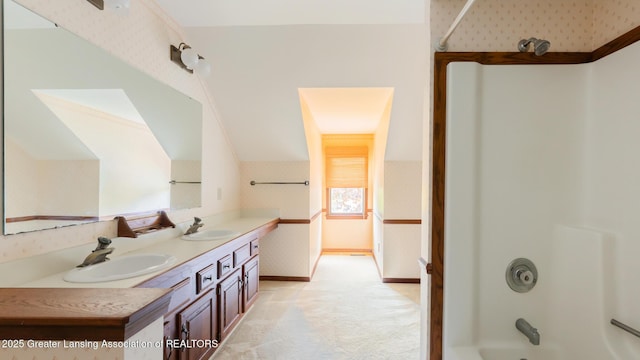 4245 Sandridge Dr, Okemos, MI 48864 - full bathroom featuring wallpapered walls, washtub / shower combination, double vanity, baseboards, and lofted ceiling