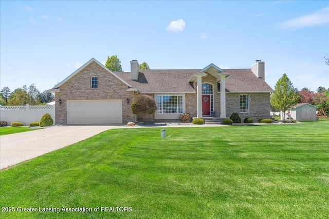 1801 Tahyio Rd, Owosso, MI 48867 - view of front of property with a chimney, concrete driveway, and a garage
