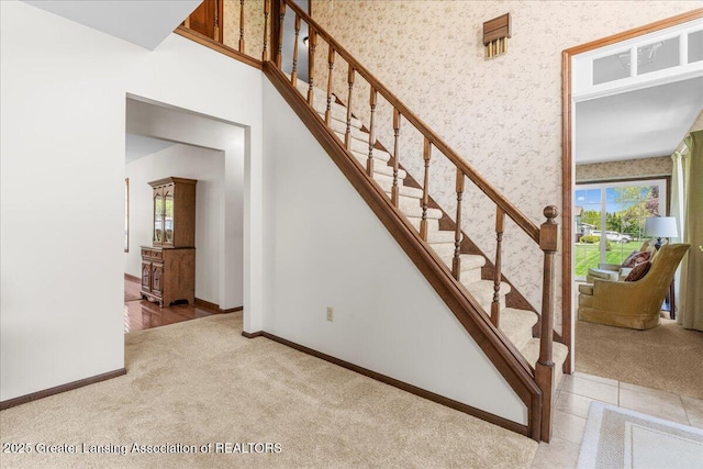 1801 Tahyio Rd, Owosso, MI 48867 - stairway featuring wallpapered walls, healthy amount of natural light, carpet, and baseboards