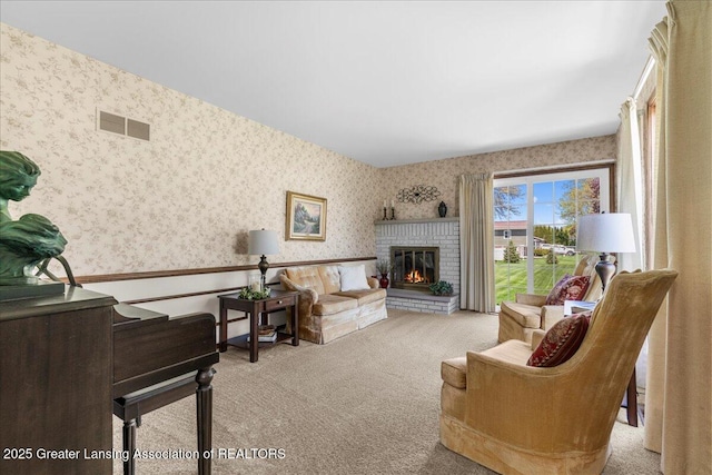 1801 Tahyio Rd, Owosso, MI 48867 - living area with wallpapered walls, carpet, a wainscoted wall, and a fireplace