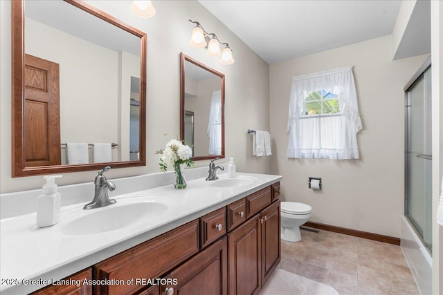 1801 Tahyio Rd, Owosso, MI 48867 - full bathroom featuring an enclosed shower, toilet, double vanity, and baseboards