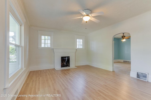 811 Princeton Ave, Lansing, MI 48915 - unfurnished living room with a ceiling fan, wood finished floors, a fireplace with flush hearth, ornamental molding, and baseboards