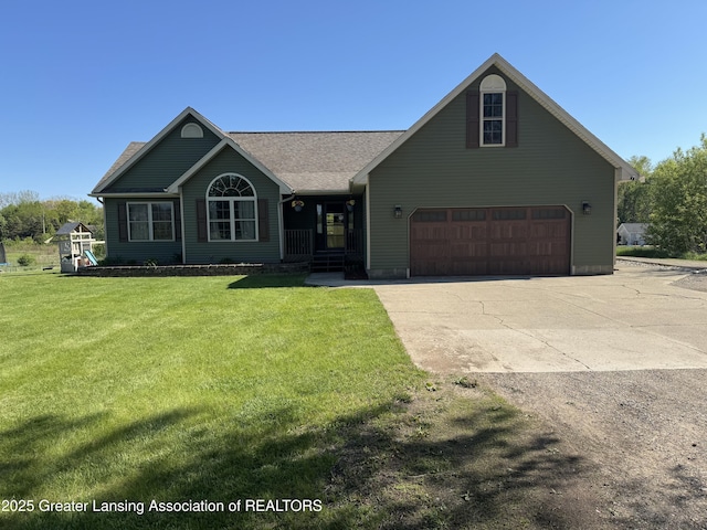 view of front facade with driveway, a front yard, and an attached garage