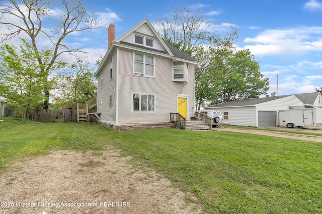 114 Haze St, Lansing, MI 48917 - back of property with a chimney and a garage