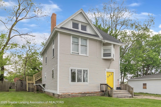 114 Haze St, Lansing, MI 48917 - view of front of house featuring a chimney and roof with shingles