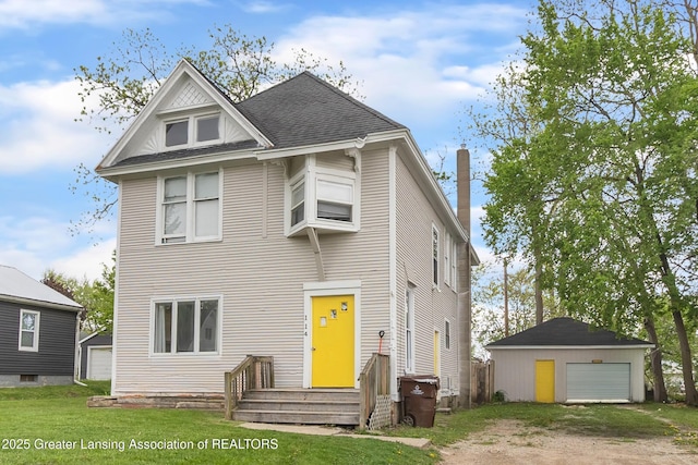 114 Haze St, Lansing, MI 48917 - view of front facade featuring an outbuilding, a detached garage, a front lawn, and roof with shingles