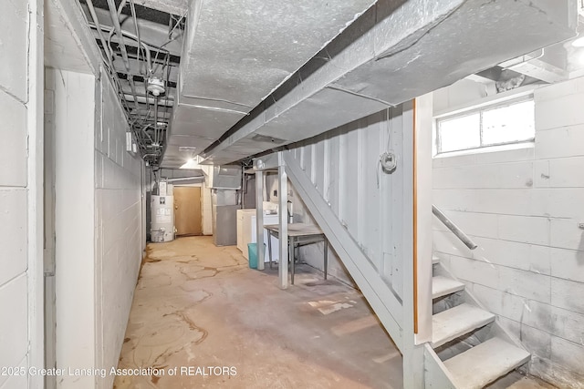 114 Haze St, Lansing, MI 48917 - basement featuring stairway, water heater, and washer / dryer