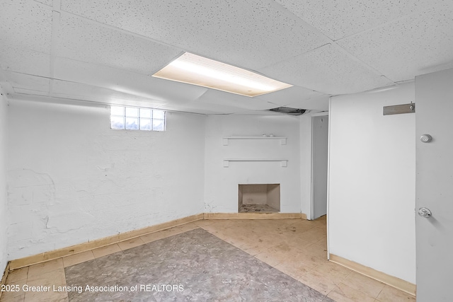 114 Haze St, Lansing, MI 48917 - below grade area featuring a paneled ceiling and baseboards