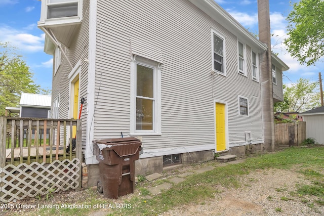 114 Haze St, Lansing, MI 48917 - view of side of home featuring fence and a wooden deck