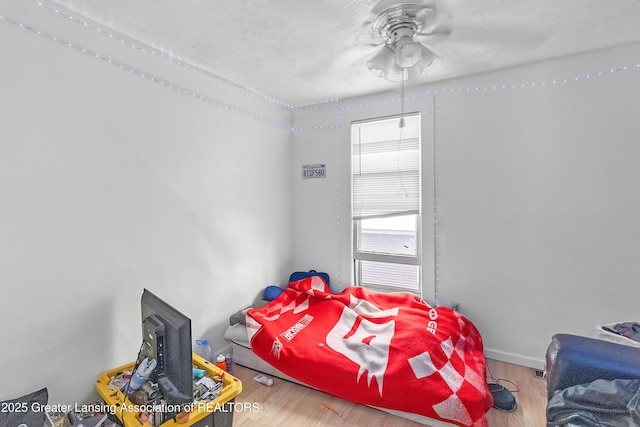 114 Haze St, Lansing, MI 48917 - bedroom with wood finished floors, baseboards, a ceiling fan, and a textured ceiling