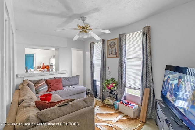 114 Haze St, Lansing, MI 48917 - living area featuring a ceiling fan and a textured ceiling