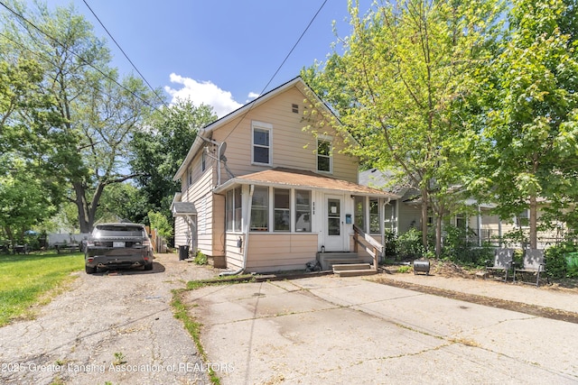 922 Dakin St, Lansing, MI 48912 - view of front of home with driveway, a sunroom, and entry steps