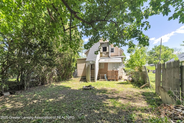 922 Dakin St, Lansing, MI 48912 - rear view of house with fence and a shingled roof