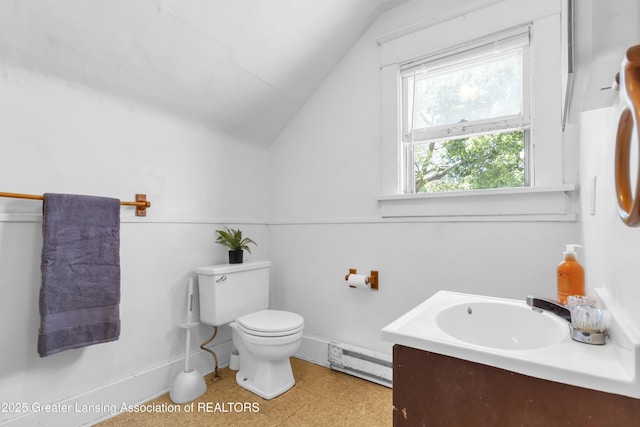 922 Dakin St, Lansing, MI 48912 - bathroom featuring a baseboard heating unit, vaulted ceiling, toilet, baseboards, and tile patterned floors